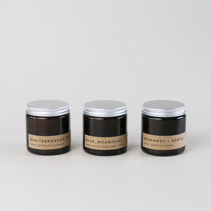 gift set of three small amber jar candles with aluminium lid with minimal brown labels, in scents inspired by nature
